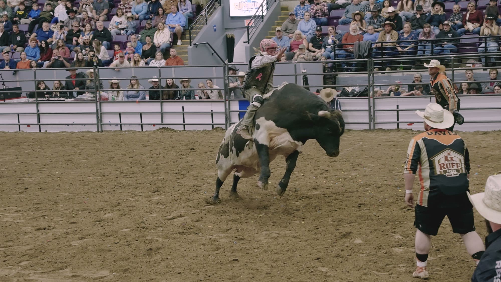 A bull rider in front of full stands at Buck Rope Rodeo